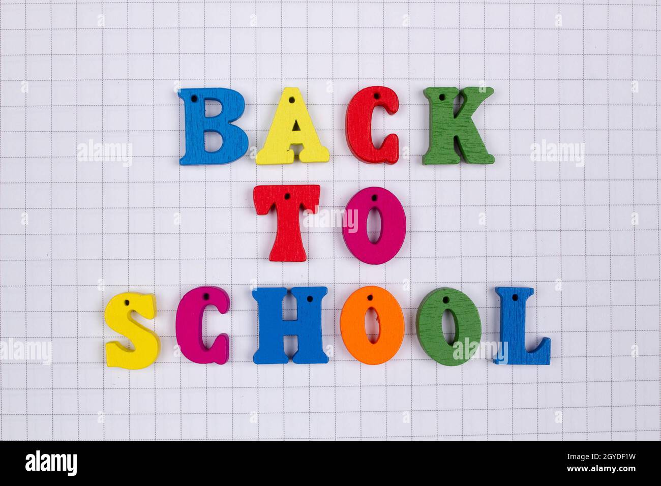 Inscription of the words of the slogan Back to school in multicolored
