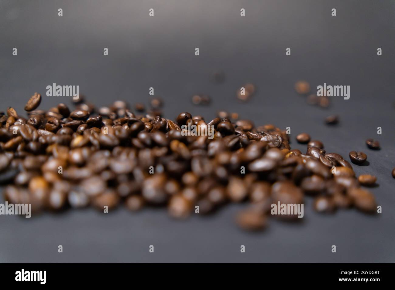 Pile of roasted coffee beans with dark gray background Stock Photo - Alamy