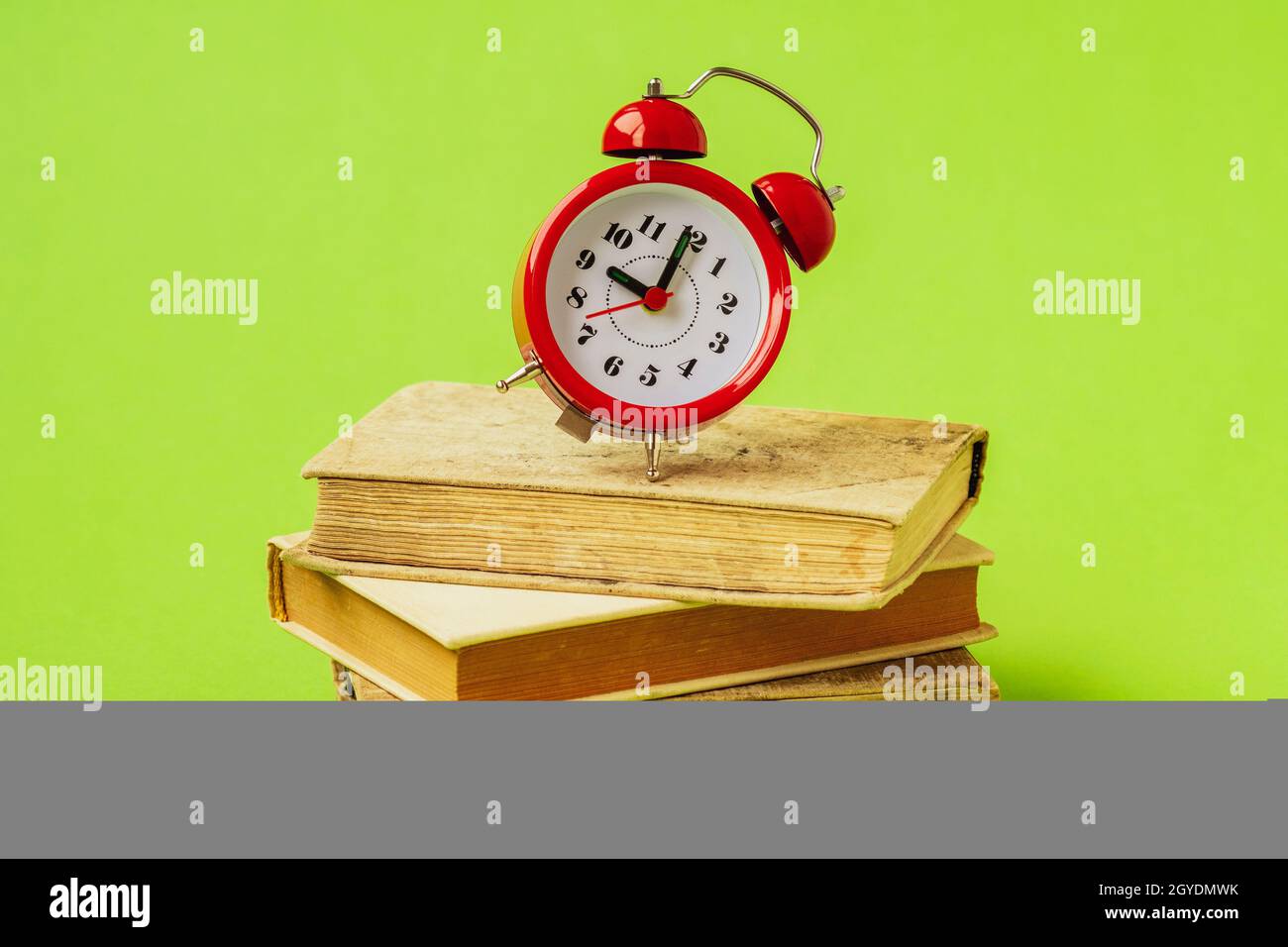 Stack of books with alarm clock. Time for reading, concentration in ...