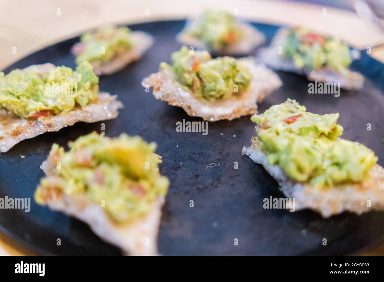 Pork rinds with guacamole on traditional Mexican comal Stock Photo Alamy