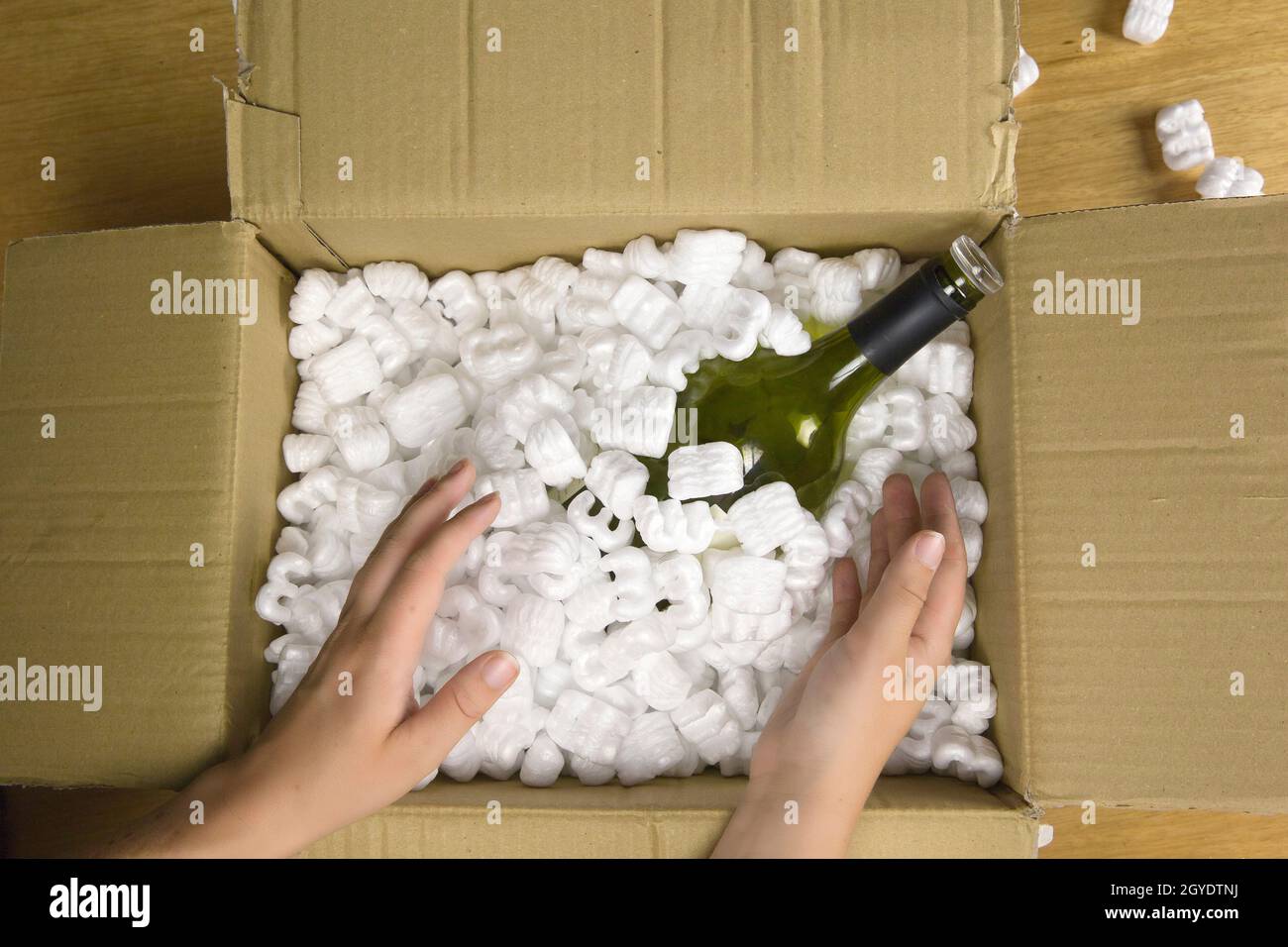 https://c8.alamy.com/comp/2GYDTNJ/wine-bottle-in-fragile-delivery-package-top-view-opened-mail-with-champange-bottle-servicedeliverytransportalcohol-concept-closeup-2GYDTNJ.jpg