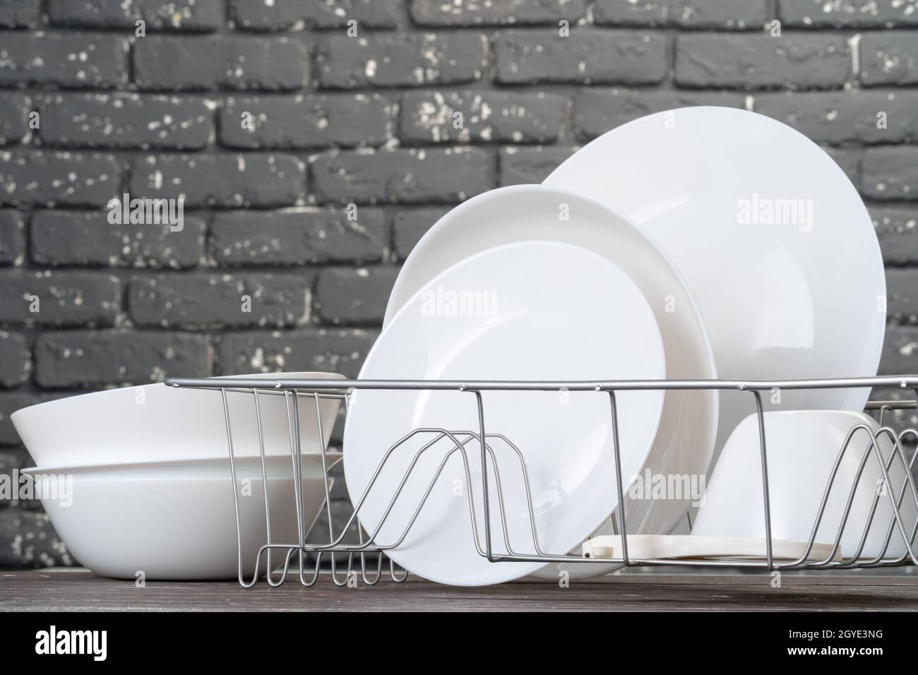 Dish rack with clean dry dishes on kitchen counter Stock Photo Alamy