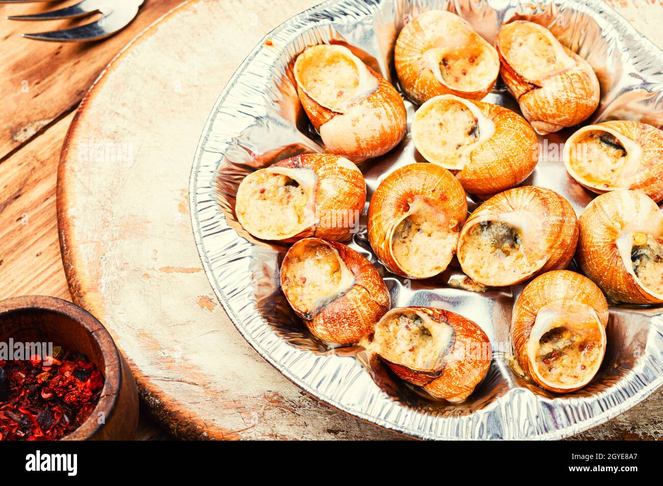 Edible snails stuffed with green butter, French delicacies Stock Photo
