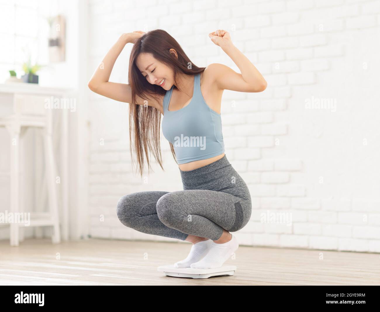 Young Healthy Girl On Home Scales Stock Photo - Download Image Now