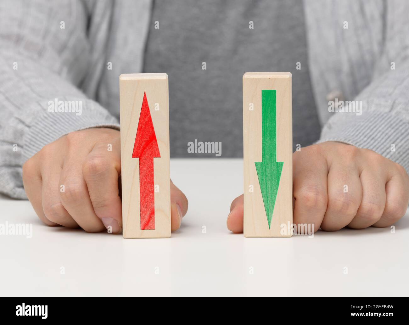 female hand holds wooden blocks with up and down arrows. The concept of lowering and increasing indices, exchange rates. Dynamics Stock Photo