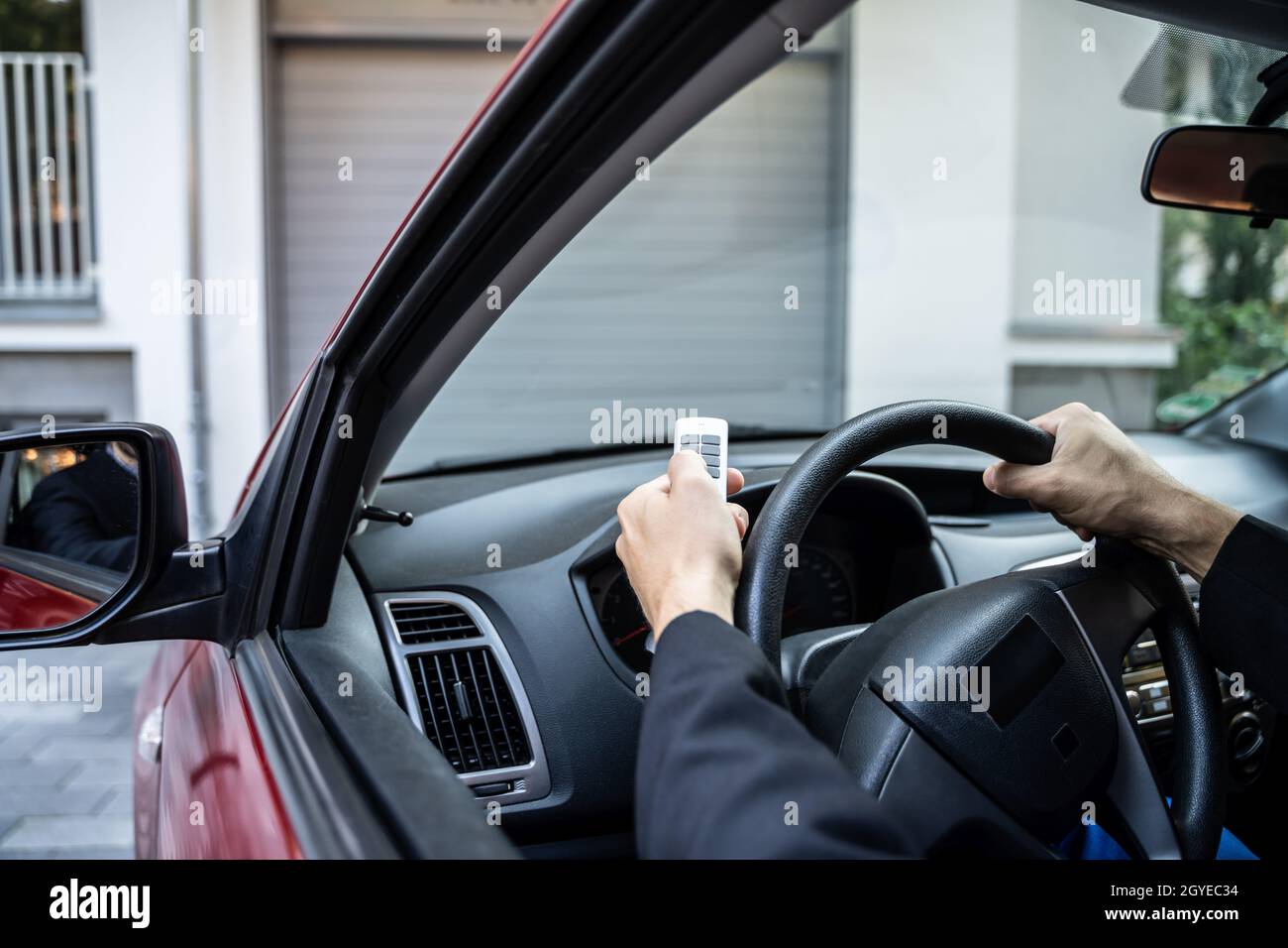 Automatic Wireless Home Garage Door. Hand Using Controller In Car Stock Photo