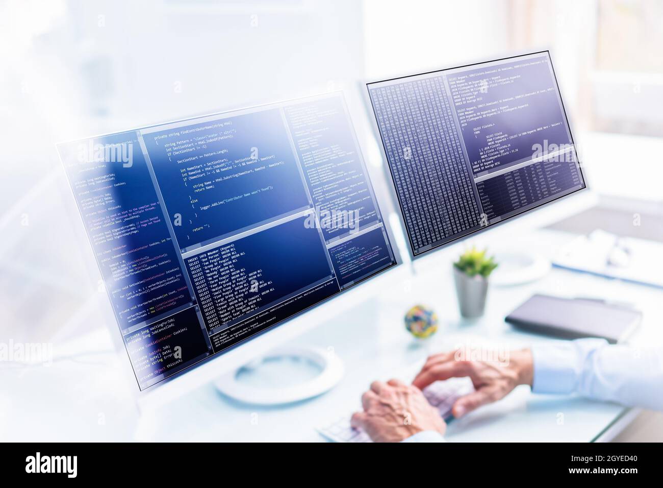 Computer Programmer Using Multiple Monitor Screens. Engineer In Office ...