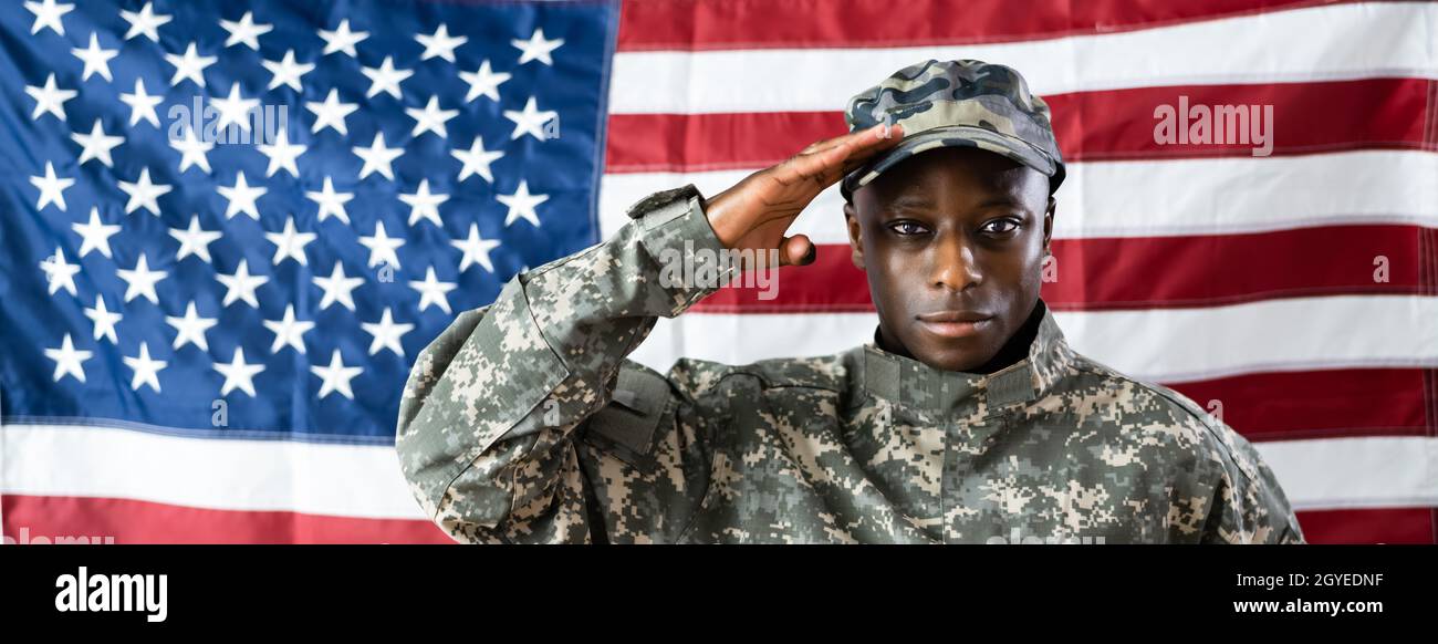 African American Army Soldier Saluting In Front Of American Flag Stock Photo