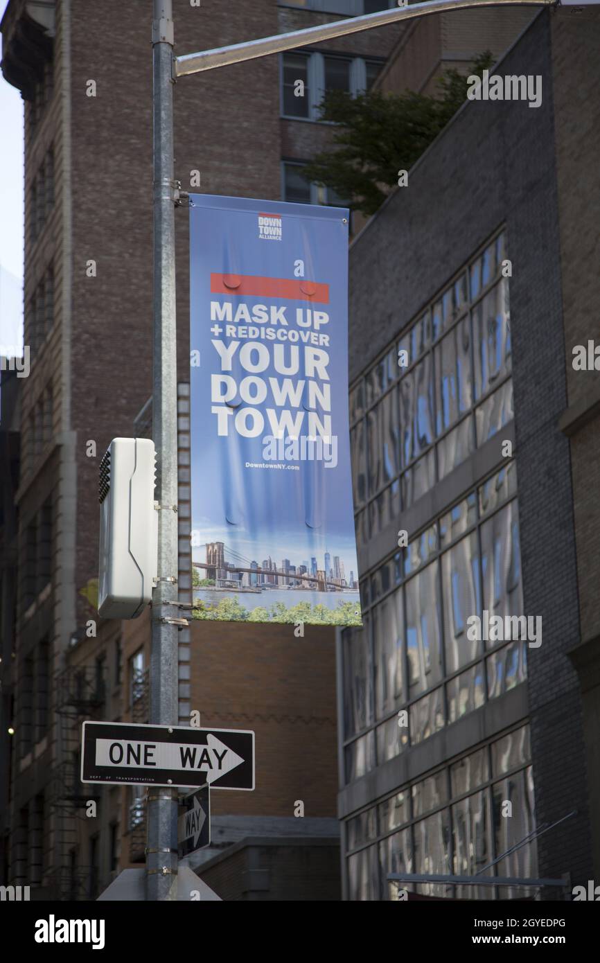 Banners hang from light posts in New York City encouraging people to 'mask up' and enjoy what NYC has to offer. Stock Photo