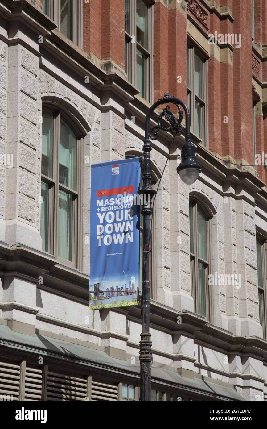 Banners hang from light posts in New York City encouraging people to 'mask up' and enjoy what NYC has to offer. Stock Photo