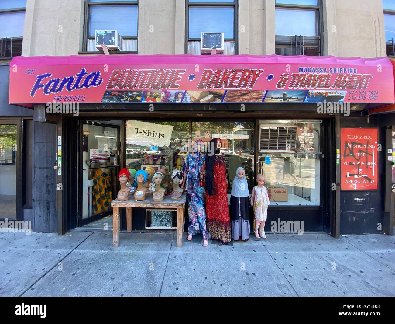 Outdoor store display on Adam Clayton Powell Blvd in Harlem reflects