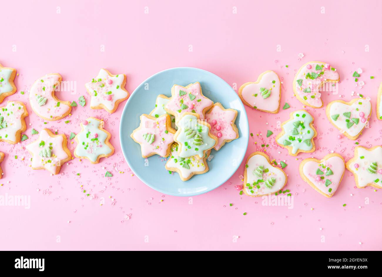 Colorful Christmas cookies with sugar sprinkles on a pink background Stock Photo
