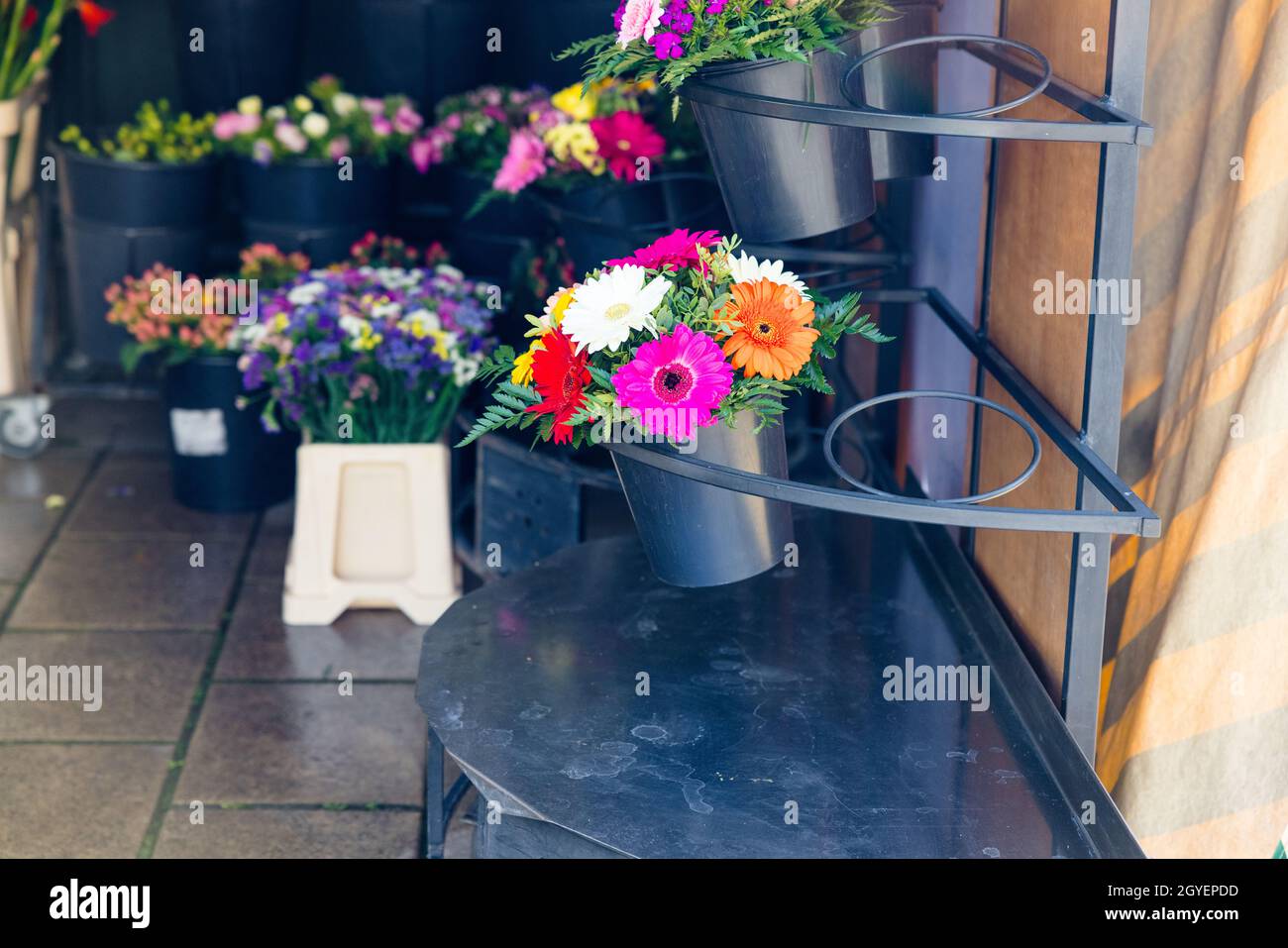 Selective ofcus shot of pots with colorful flowers on a shop Stock Photo