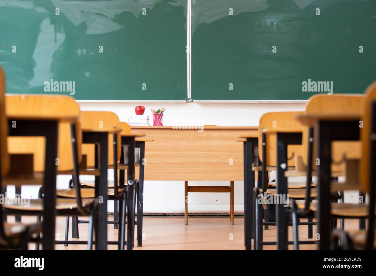 Back to School Concept. Empty classroom with chairs, desks and chalkboard. Stock Photo