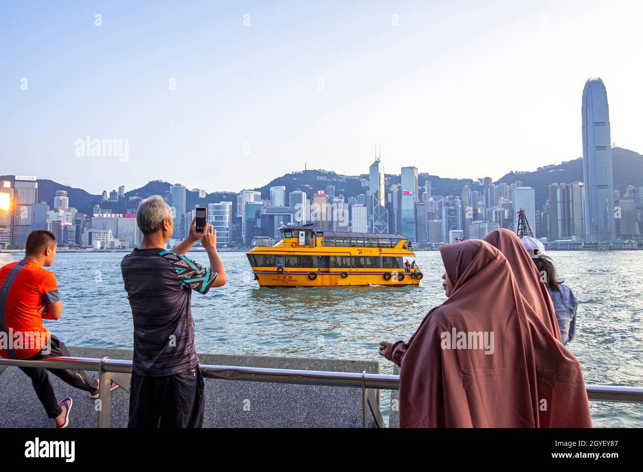 Tourists in front of Hong Kong Island. Stock Photo