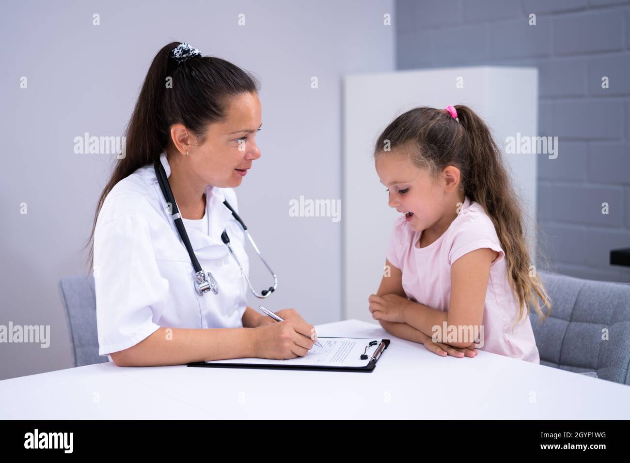 Sick Child Therapy. Therapist Comforting Kid At Hospital Stock Photo