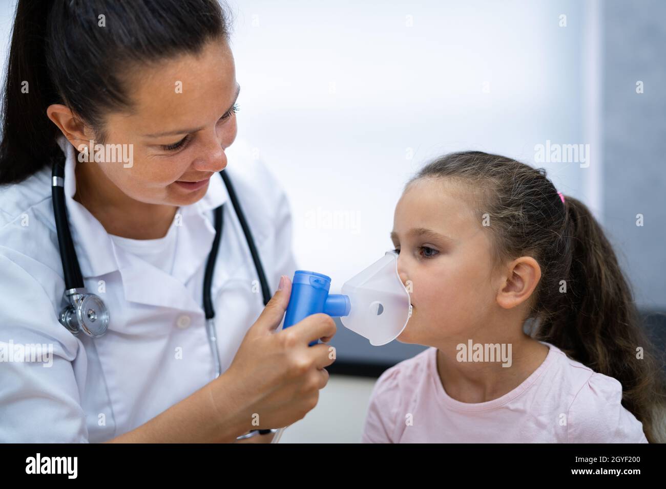 Doctor Giving Young Girl Respiratory Asthma Inhaler For Breathing Stock