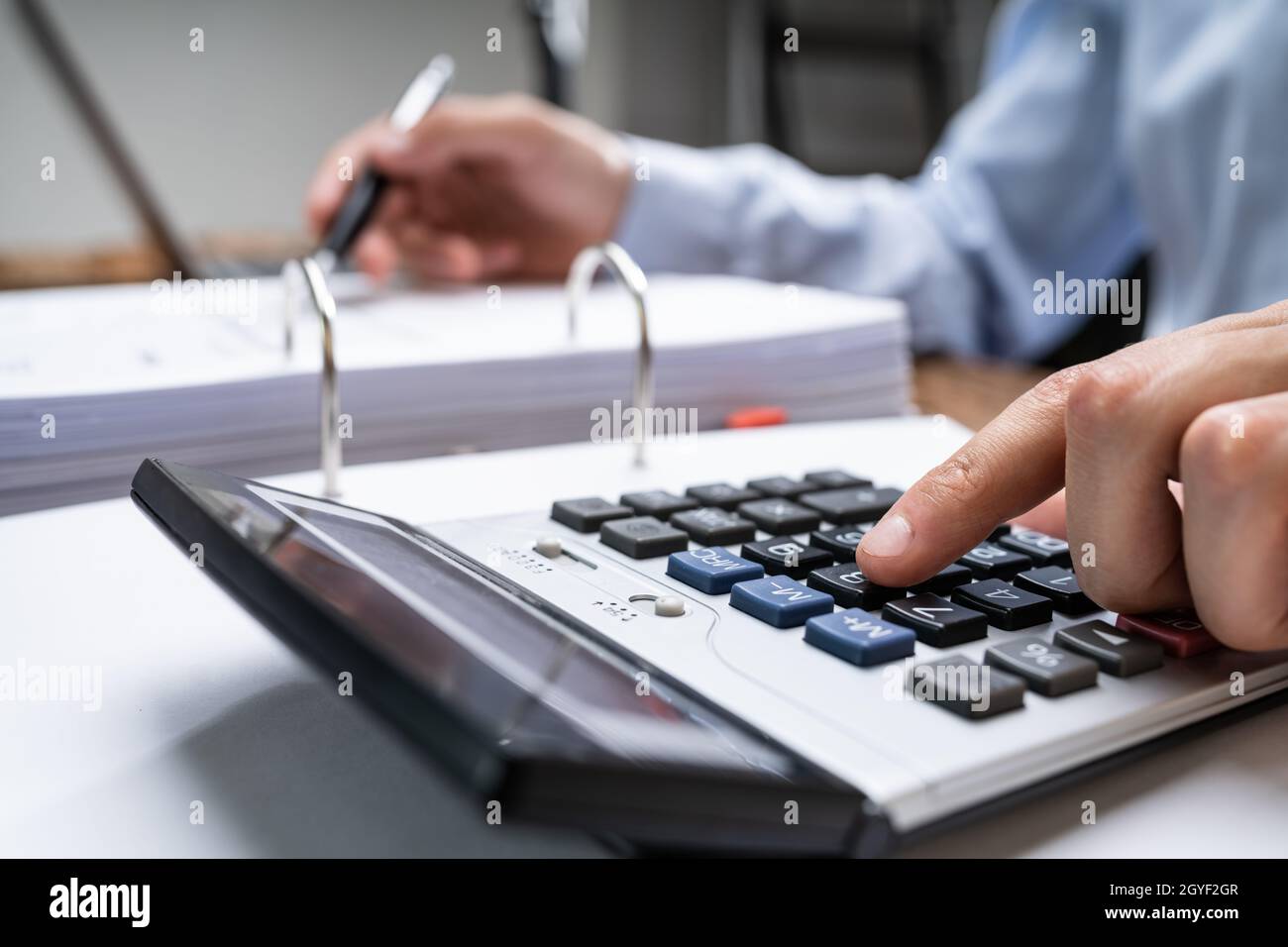 Chartered Accountant Calculating Salary Taxes And Receipts Stock Photo