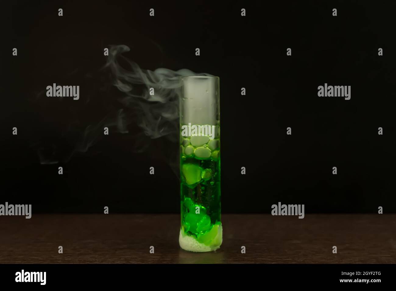 Dry ice reacts with green water to produce smoke Stock Photo Alamy