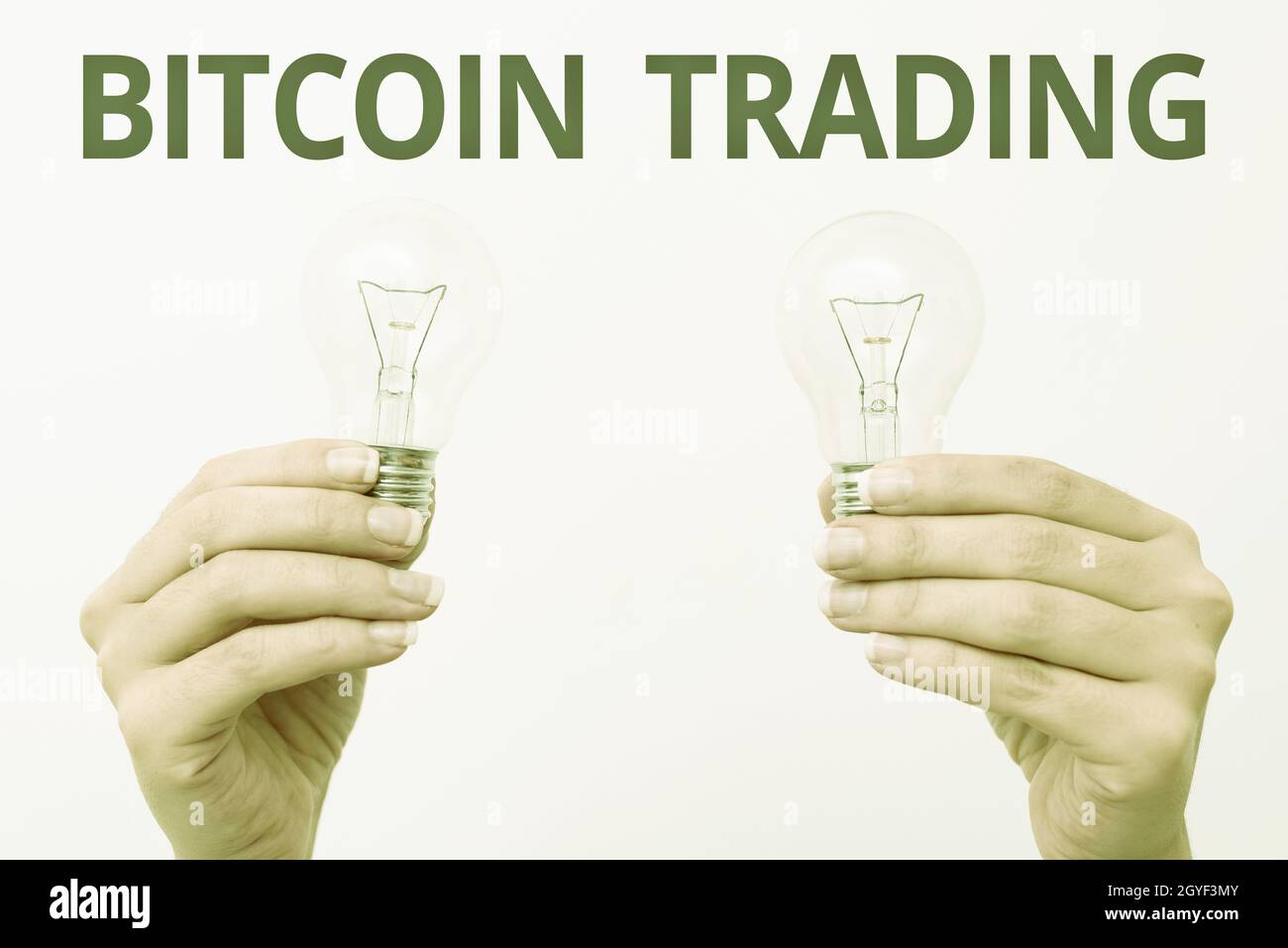 Writing displaying text Bitcoin Trading, Business overview buying and selling of cryptocurrency in stocks market two Hands holding lamp showing or pre Stock Photo