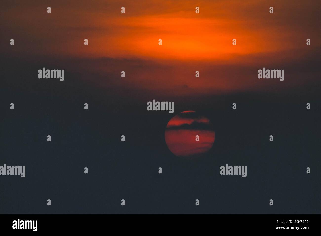 Beautiful sunset. Dramatic Fiery Sun Surrounded by Clouds During Sunset ...