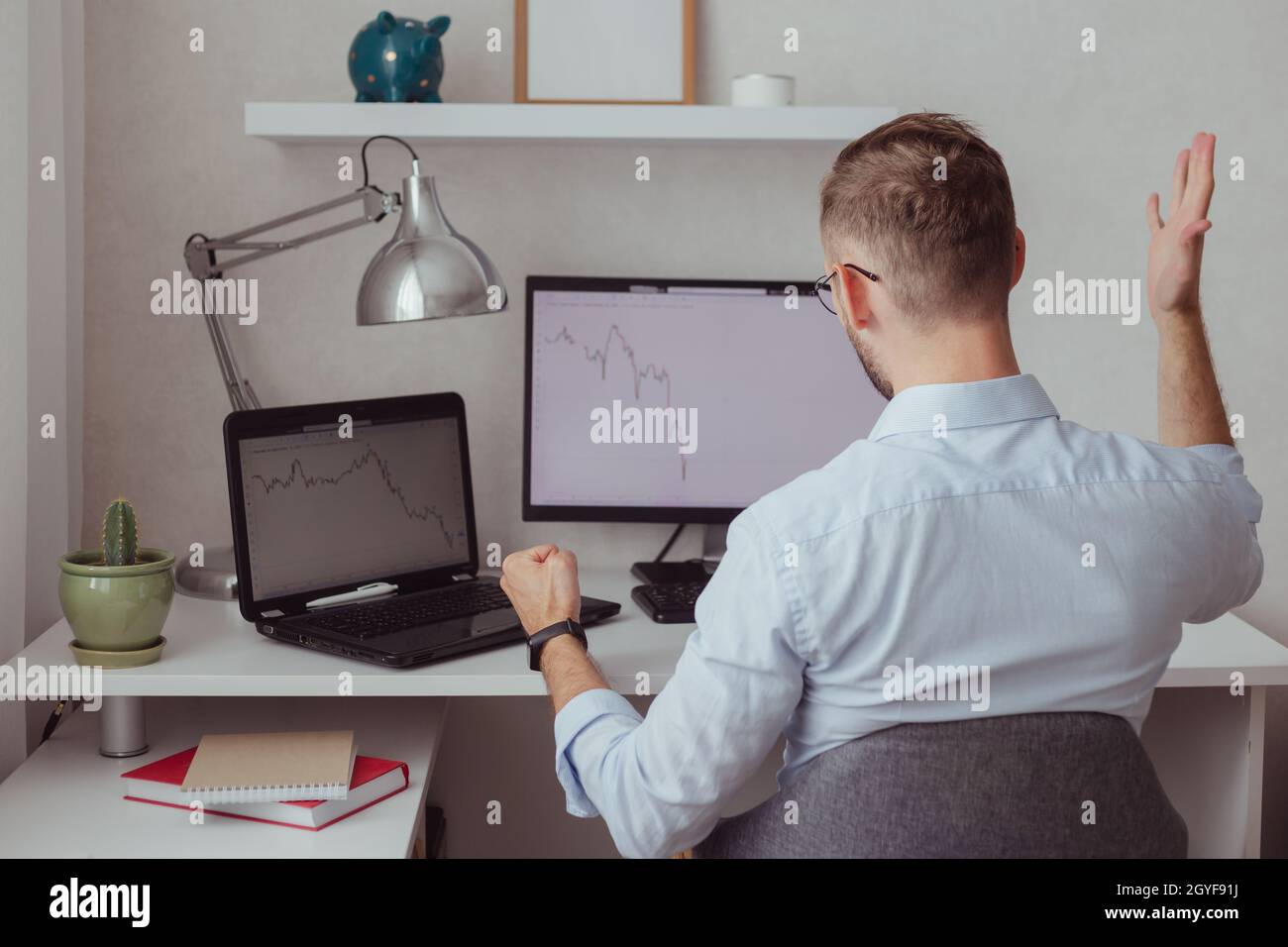 Angry man investor-trader in front of monitors with charts. Stock market correction. Fall of cryptocurrency. Finance failure. Bear market. Forex Stock Photo