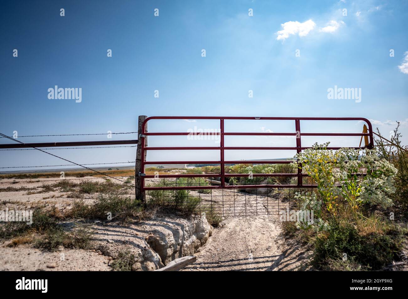 Water gap under a livestock fence where animals can go under a washed