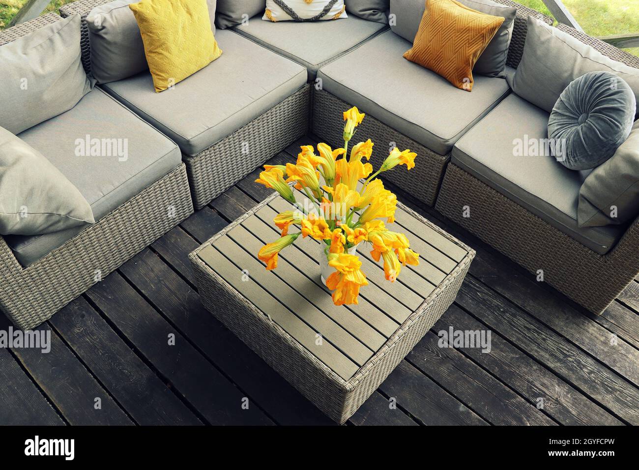 Outdoor furniture lounge group with chairs, sofa and table in a patio