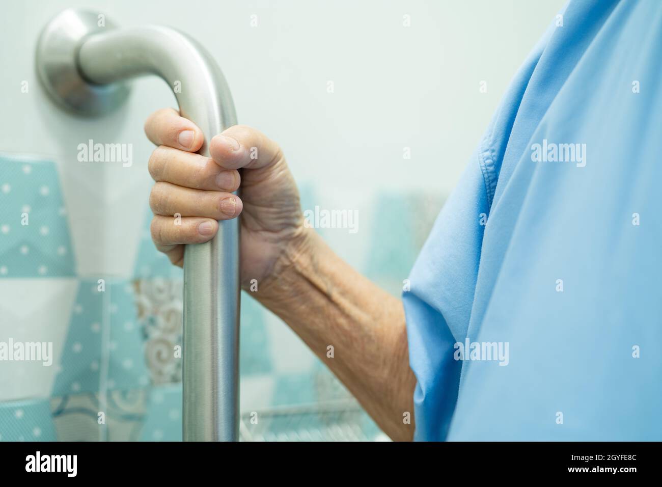 Asian senior or elderly old lady woman patient use slope walkway handle security with help support assistant in nursing hospital ward; healthy strong Stock Photo