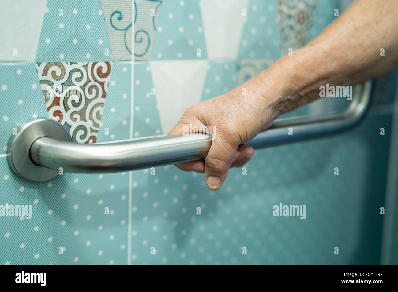 Asian senior or elderly old lady woman patient use toilet bathroom handle security in nursing hospital ward, healthy strong medical concept. Stock Photo