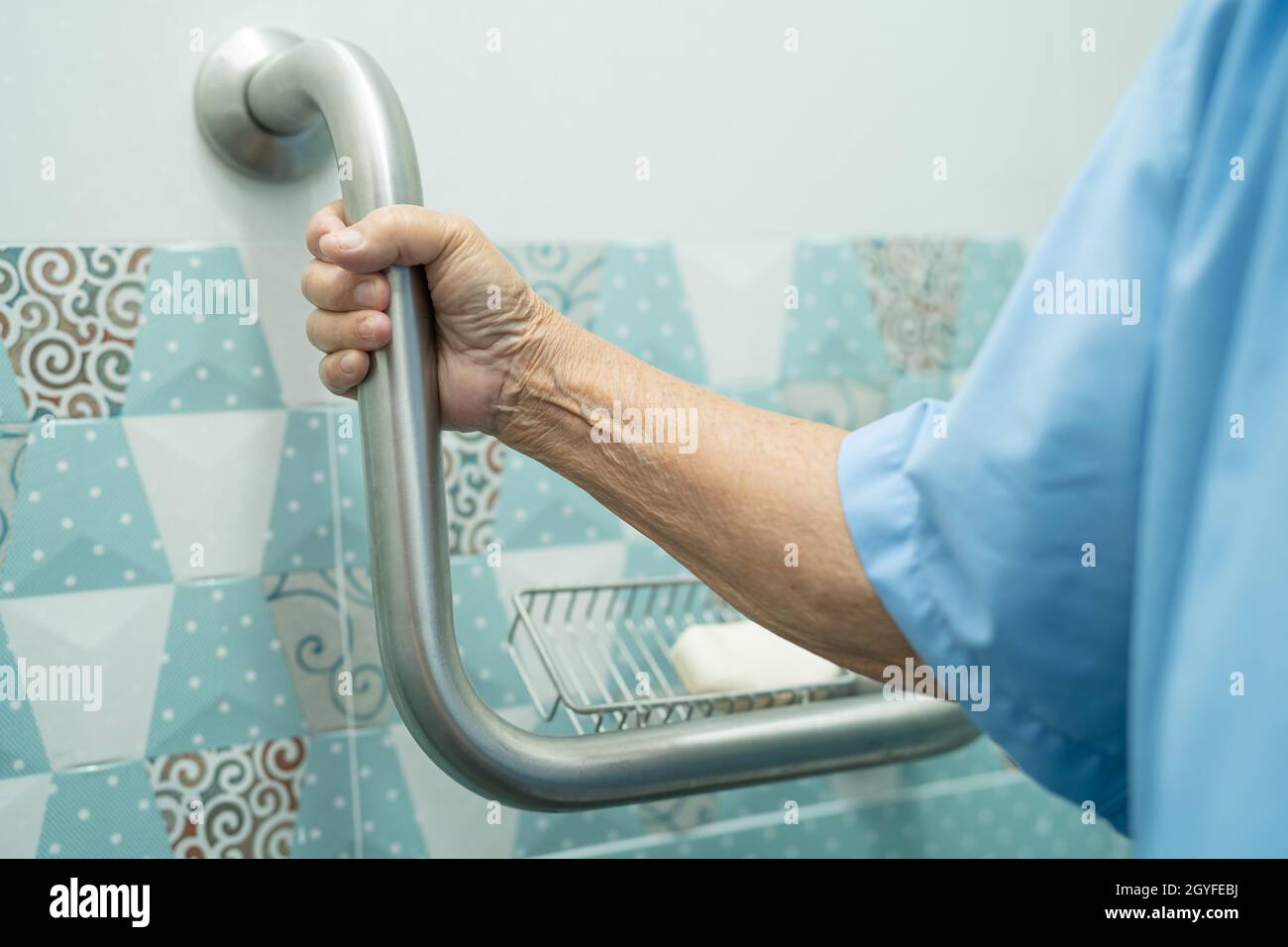 Asian senior or elderly old lady woman patient use slope walkway handle security with help support assistant in nursing hospital ward, healthy strong Stock Photo