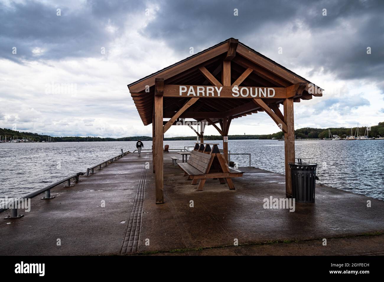 A photo of the town dock at the end of the pier on a cool, cloudy autumn day. Stock Photo