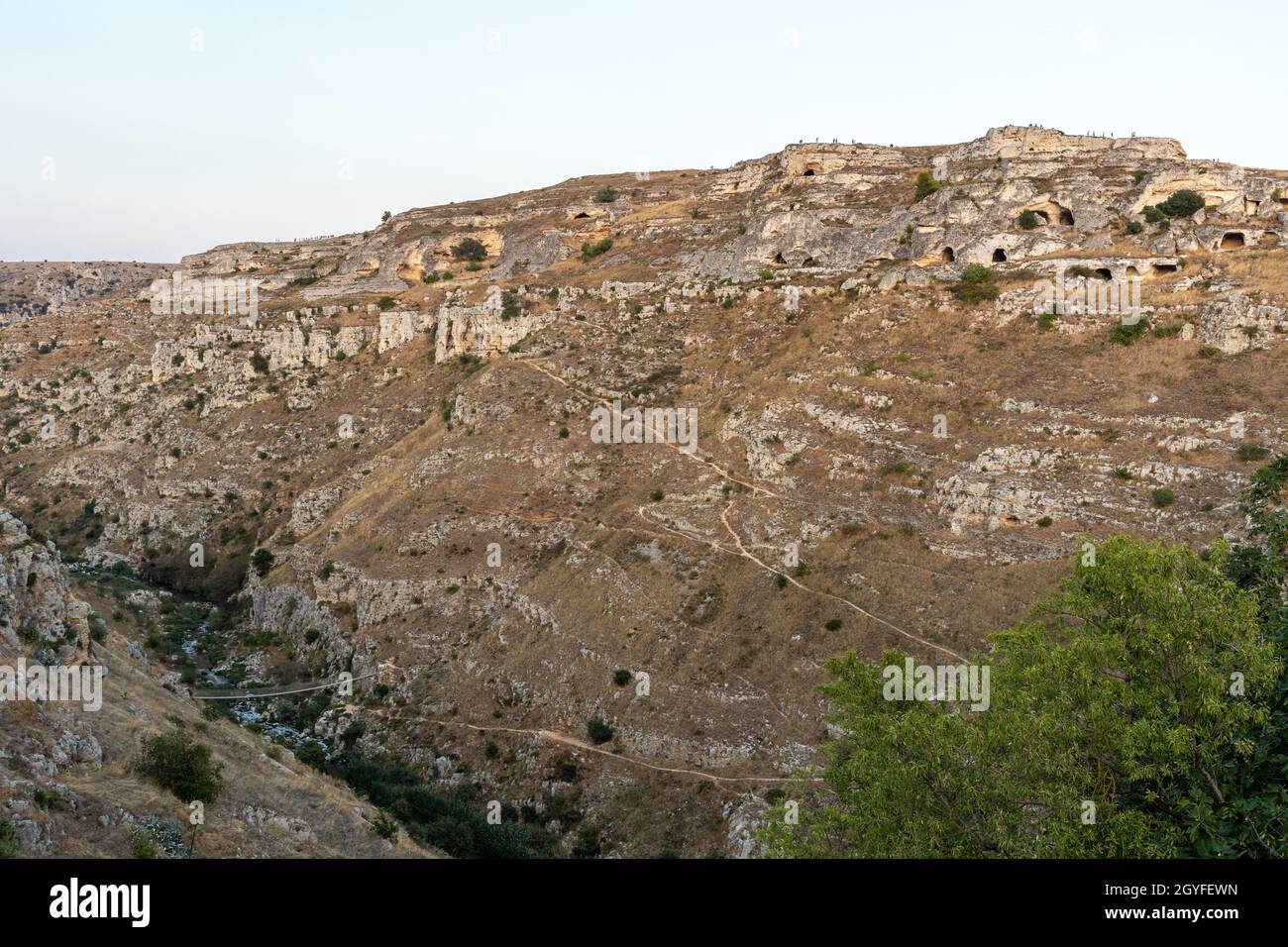 View of Gravina river canyon and park of the Rupestrian Churches of Matera with houses in caves di Murgia Timone near ancient town Matera (Sassi), , B Stock Photo