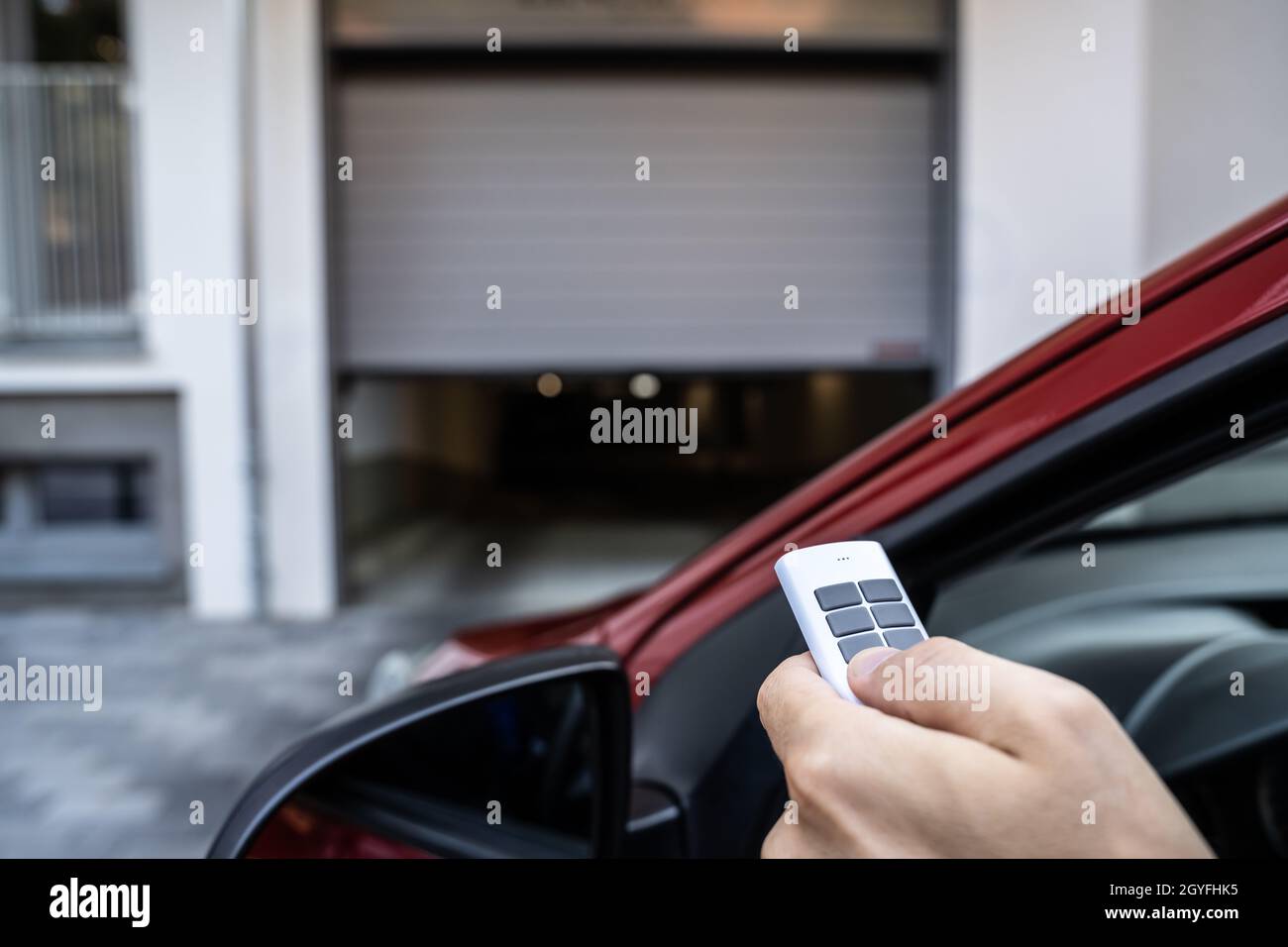 Automatic Wireless Home Garage Door. Hand Using Controller In Car Stock Photo