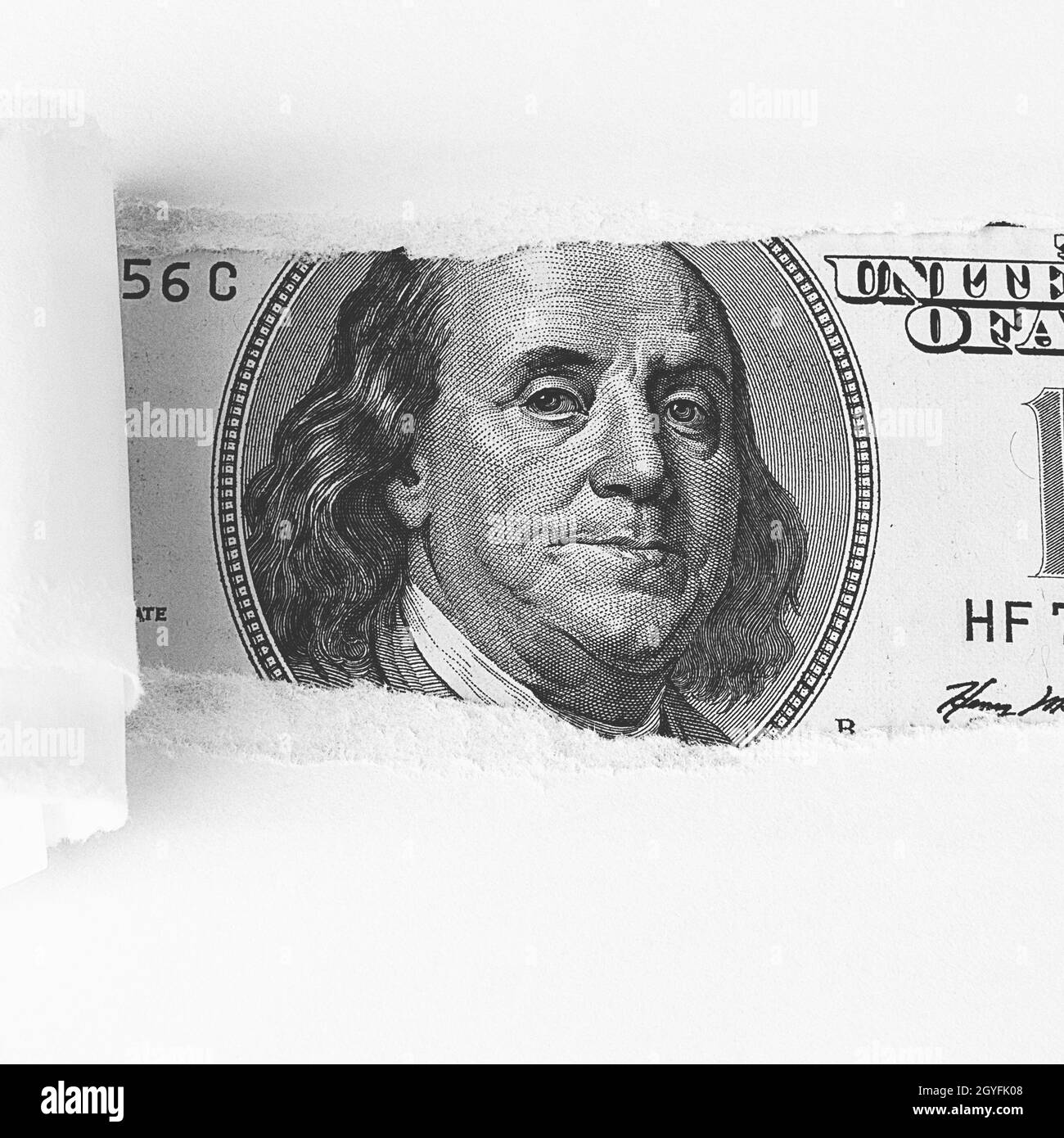 The face of Benjamin Franklin on a hundred-dollar bill, from a torn window in white paper. Background, white. Isolated. Close-up. A hundred-dollar Ame Stock Photo
