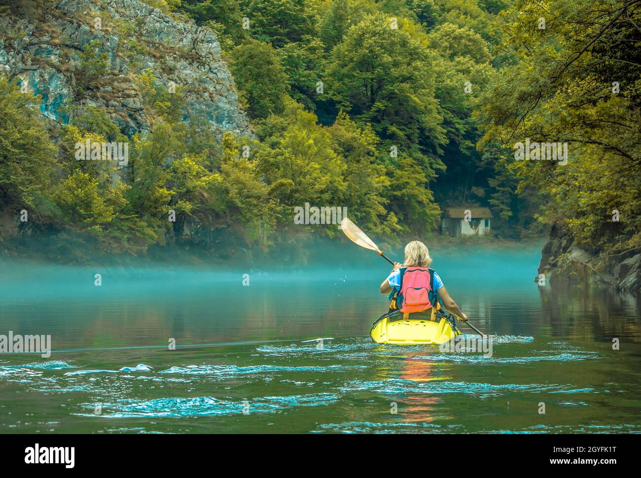 The woman in kayak in fog on mountain lake Stock Photo Alamy