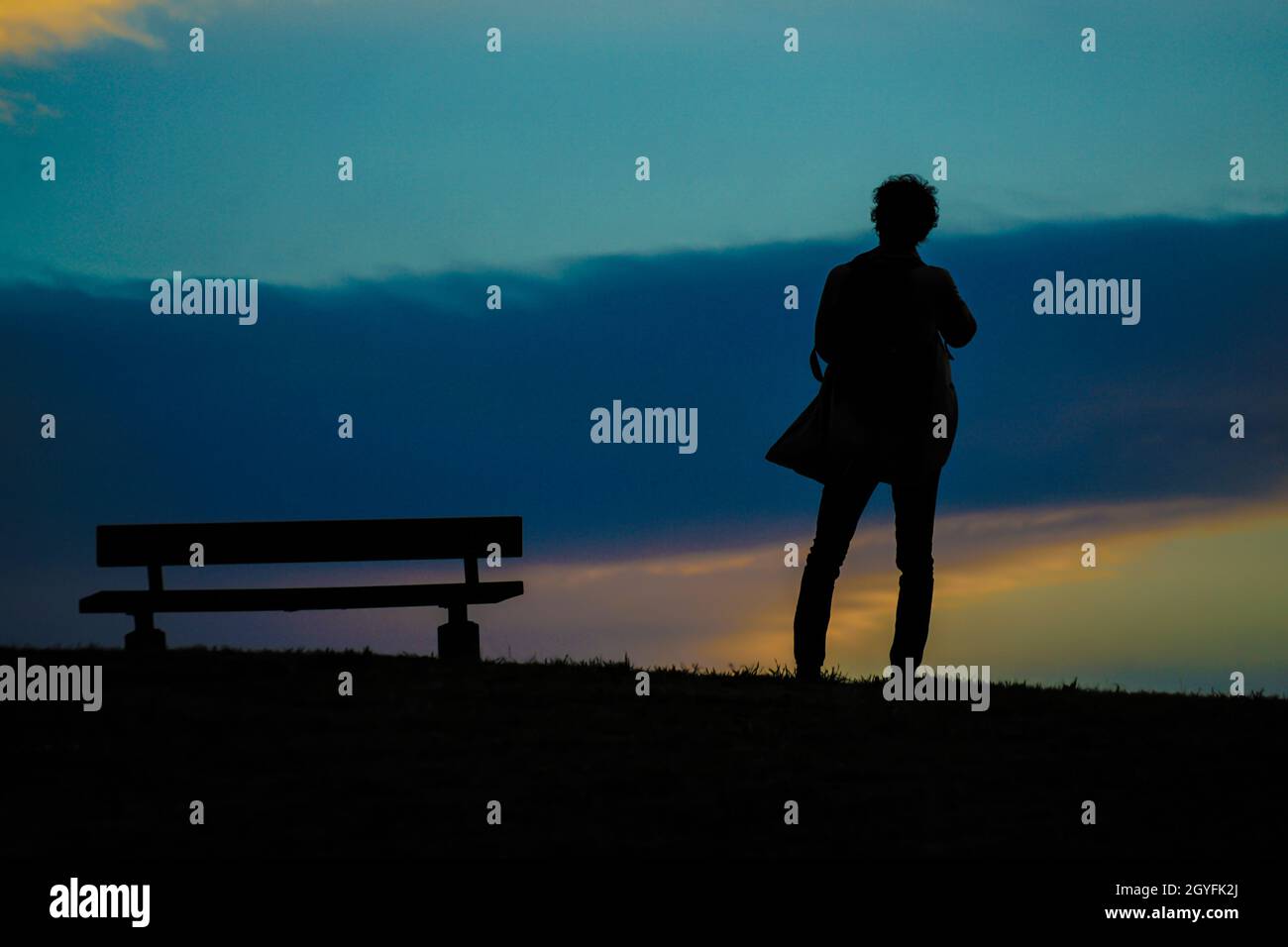 Male silhouette standing in the sunset of the hill. Shooting Location: Chofu, Tokyo Stock Photo