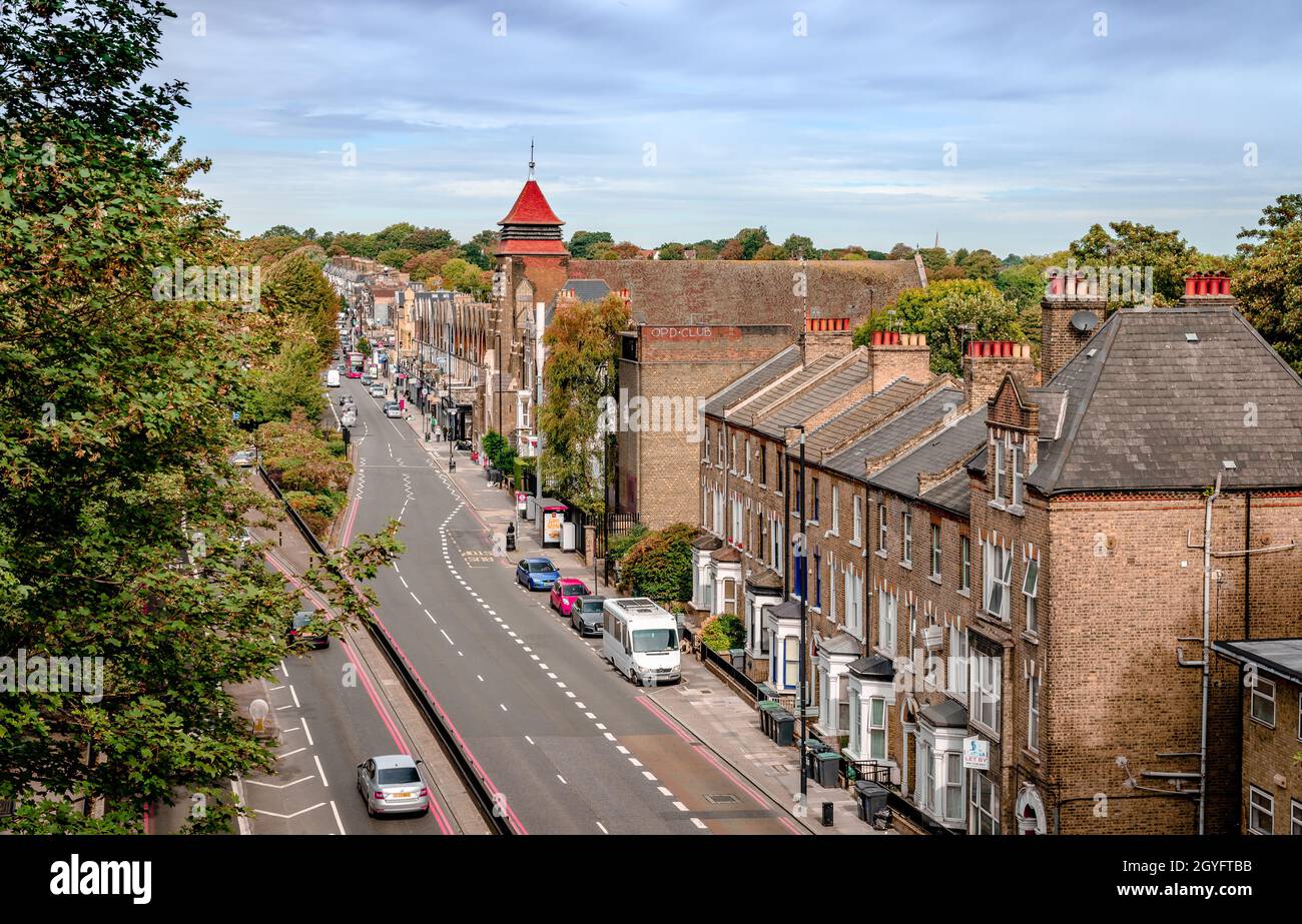 View of the A1 aka Archway Rd in Highgate, London, seen from Hornsey Ln Bridge. The steeple of the church of St Augustine is in the background. Stock Photo