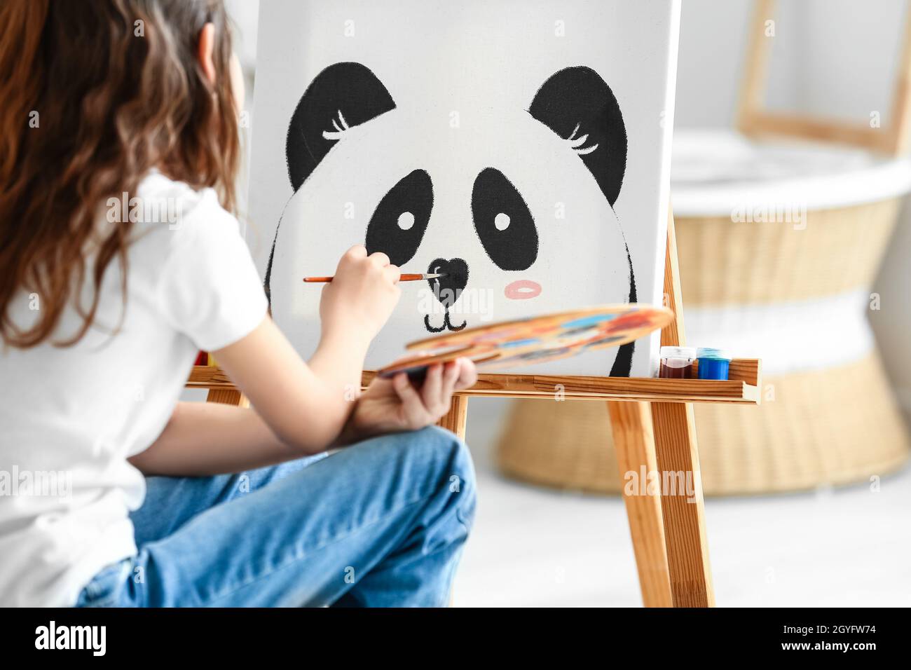 Cute little girl painting at home Stock Photo - Alamy