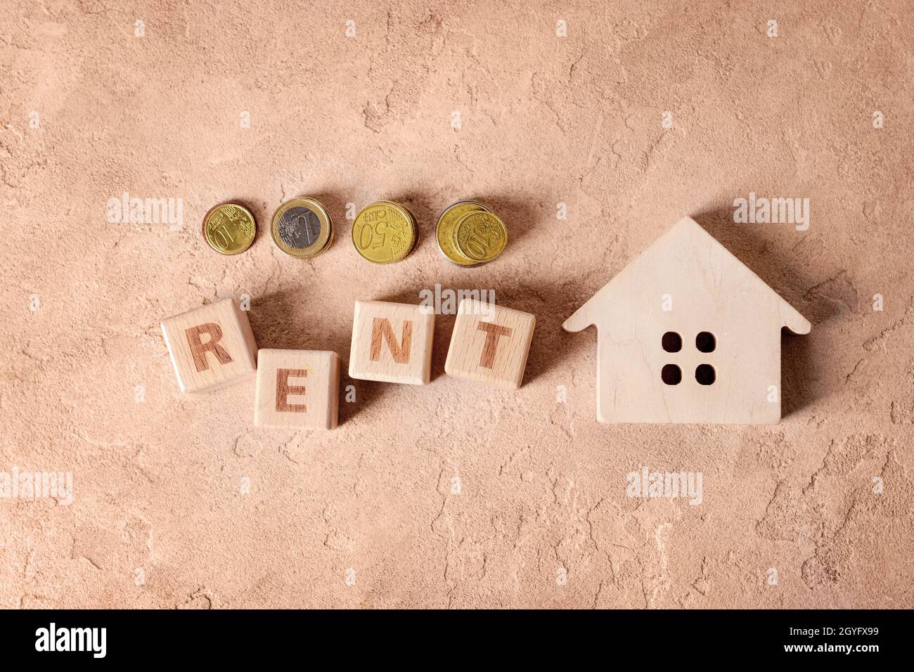 Word Renter Background Wooden house with word RENT and coins on beige background Stock Photo ...