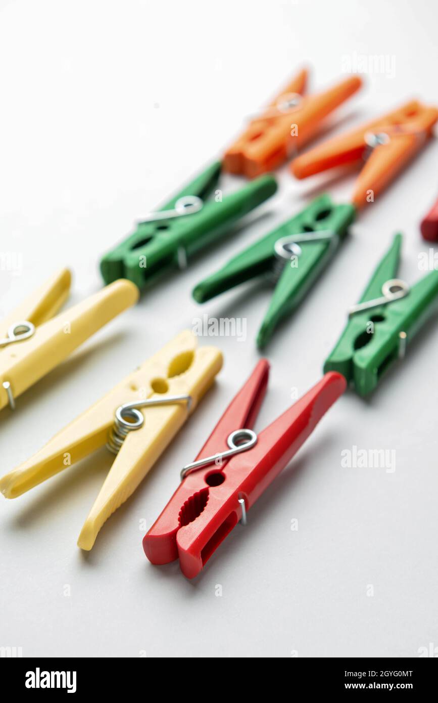 Different plastic clothespins on grey background, closeup Stock Photo