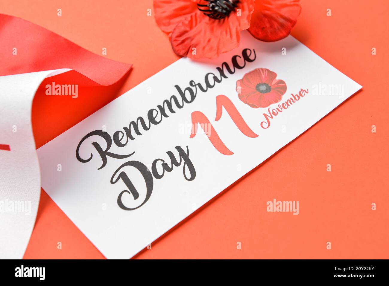 Poppy flower, card and flag of Canada on color background. Remembrance Day Stock Photo