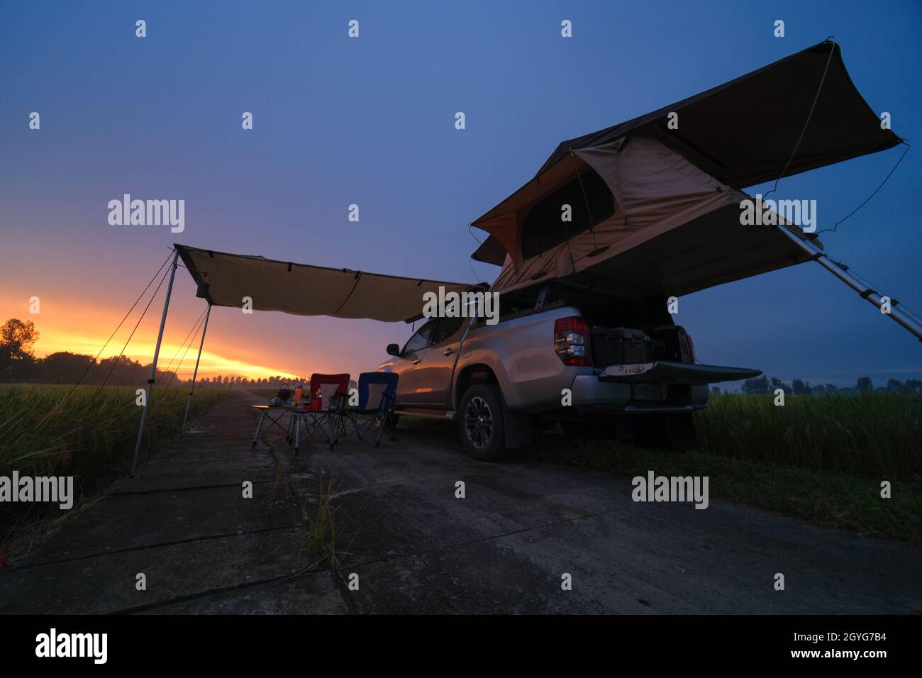 Truck With Roof Top Tent In Field Traveling By Car And Camping With Rooftop Tent Morning Landscape With Beautiful Sunrise Sky Camp Table And Chair Stock Photo Alamy