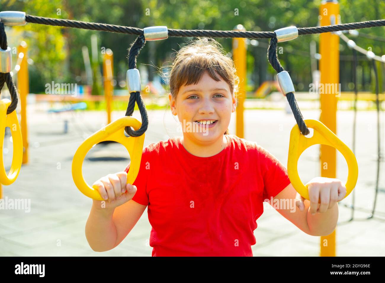 Smiling girl on outdoor playground Stock Photo
