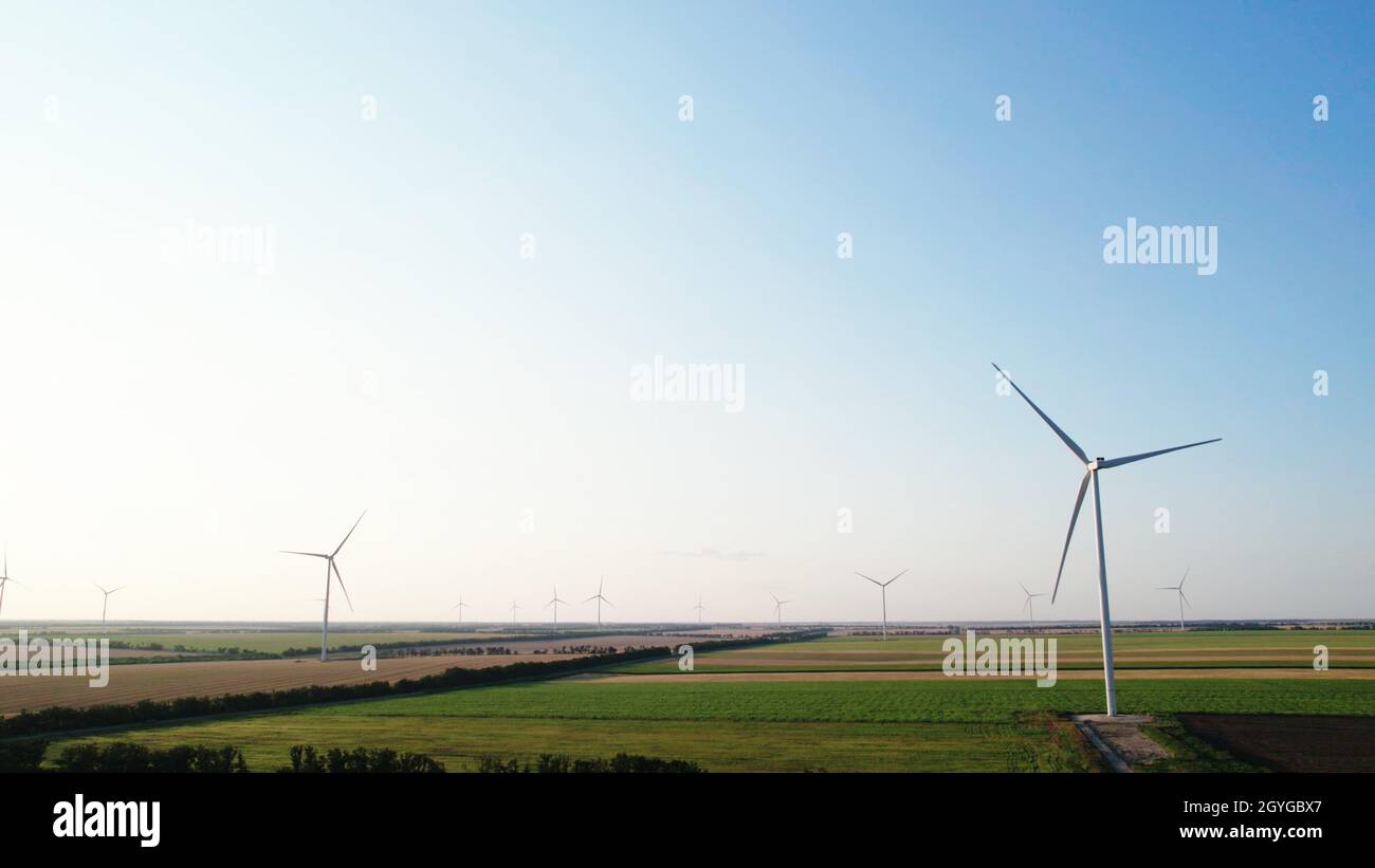 Lots of wind turbines against the blue sky. Stock Photo