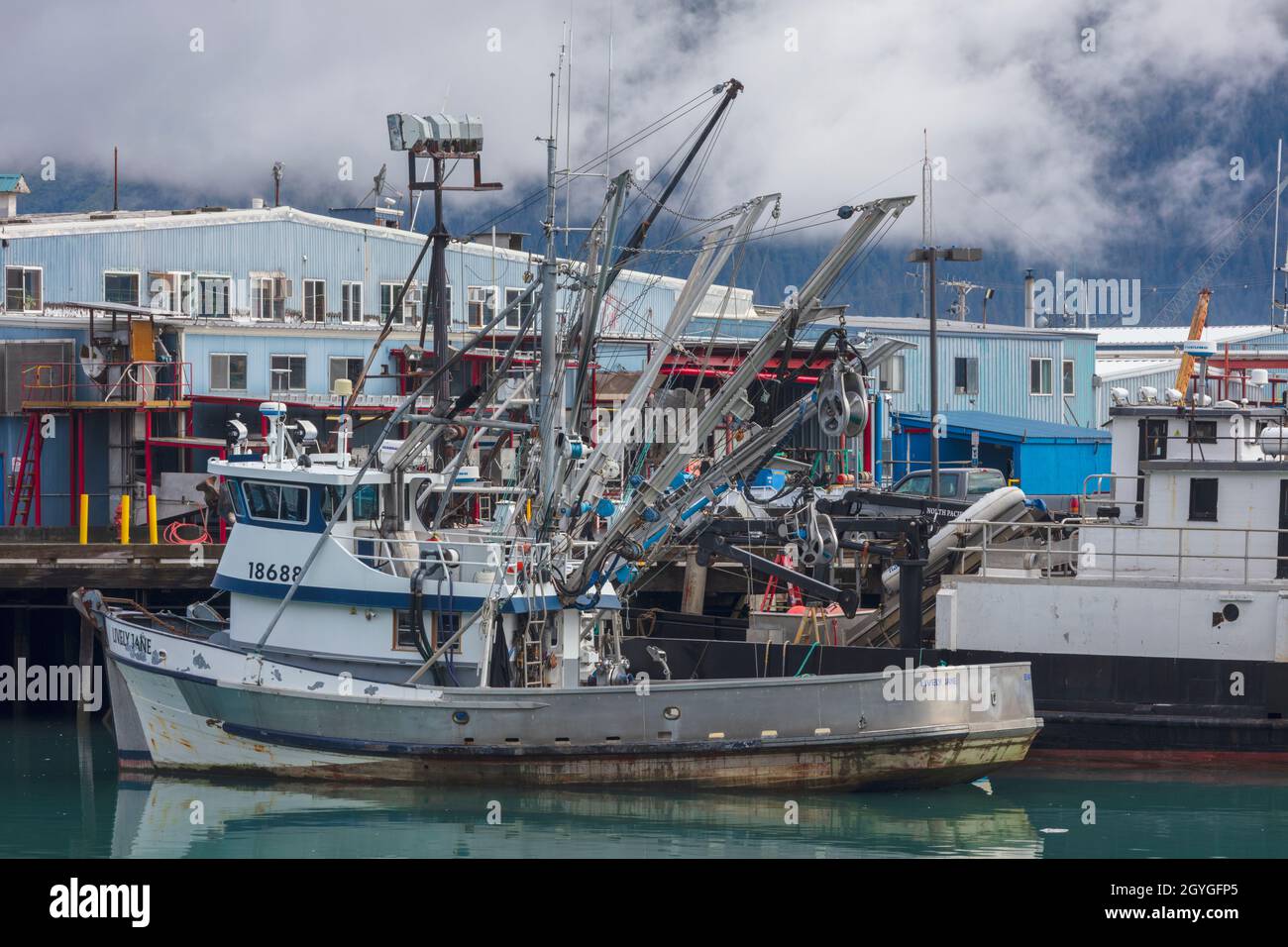 A FISHING BOAT is docked in RESURRECTION BAY in the SEWARD HARBOR of ALASKA. Stock Photo