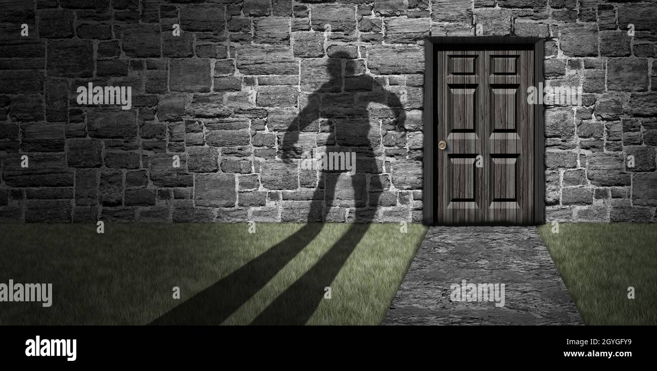 Haunted Halloween house as a creepy zombie shadow approaching an old scary mansion door at night representing an evil spirit ghost and horror. Stock Photo