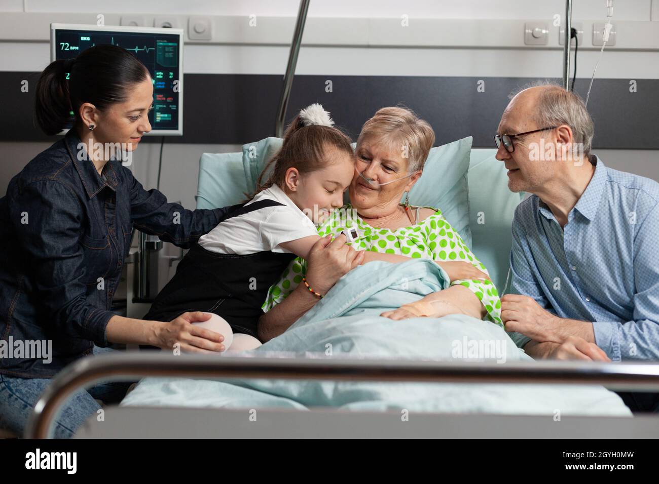 Granddaughter Hugging Sick Elderly Grandmother Visiting Her In Hospital