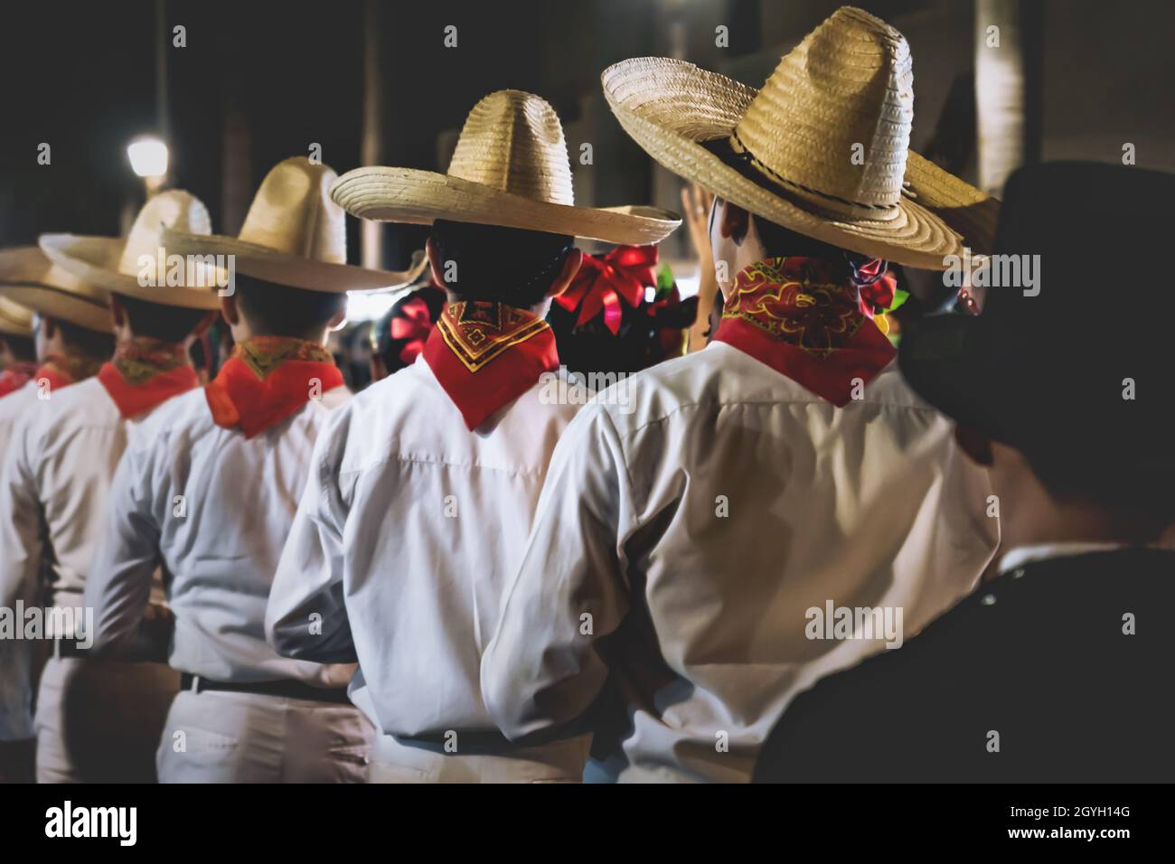 Merida, Mexico: 27 October 2018 - Men with traditional Mexican clothing and straw hats lining up before performance at 'Festival de las Animas' for da Stock Photo