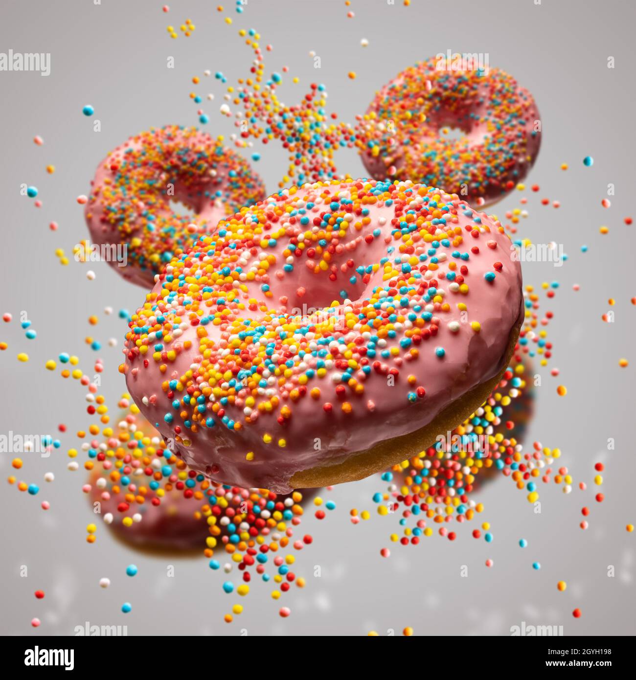 Flying sweet donuts with sprinkels on grey background Stock Photo